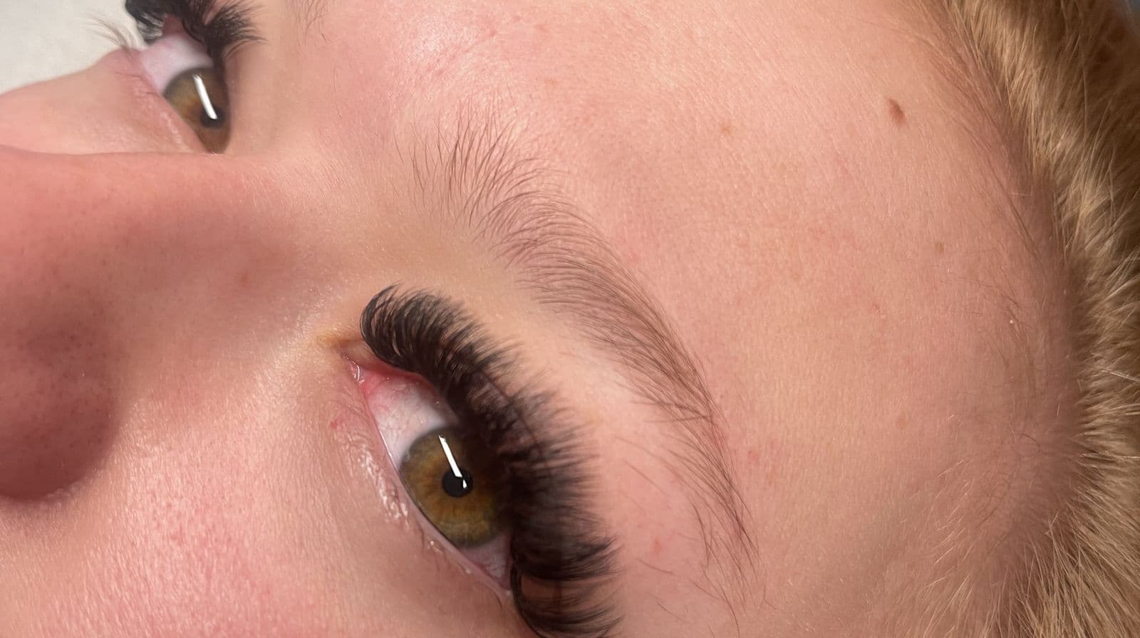 Close-up of a natural eye with full, dark lash extensions