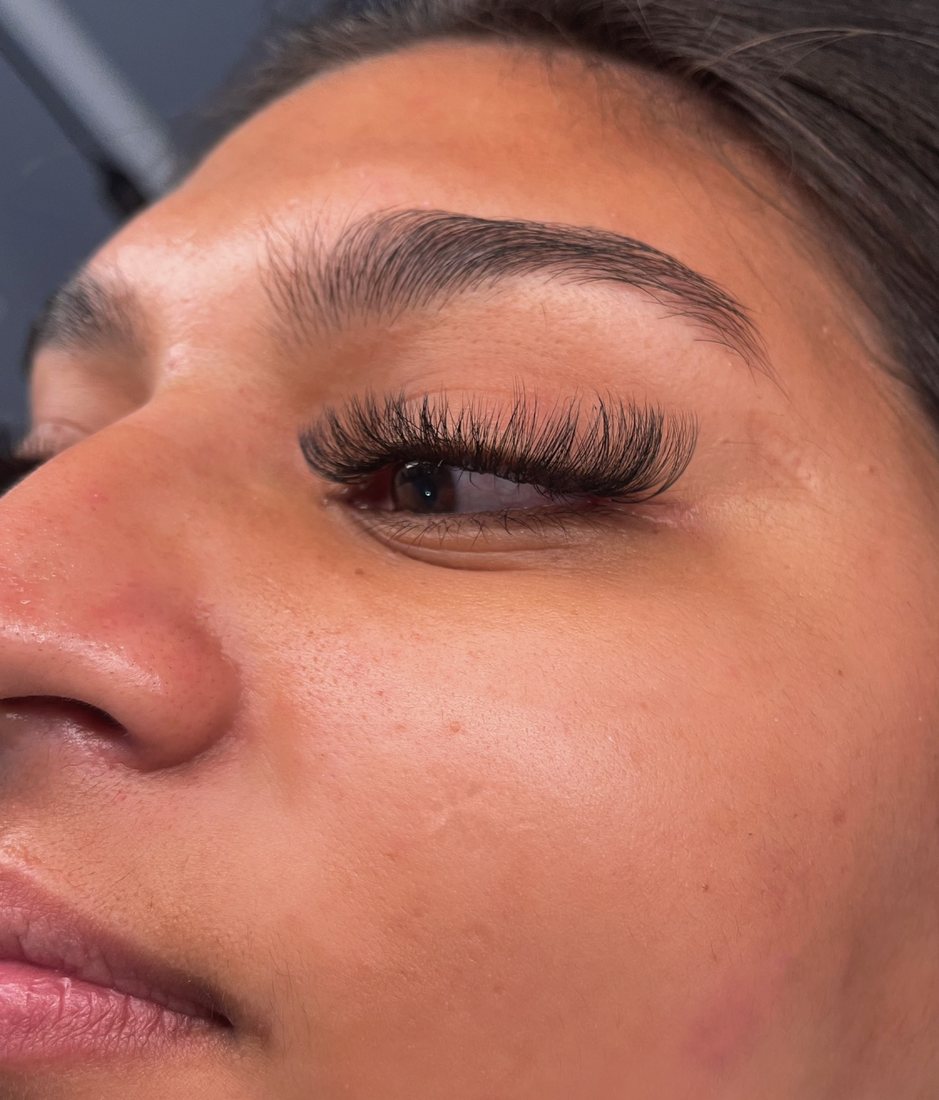 Client with full lash extensions, side view