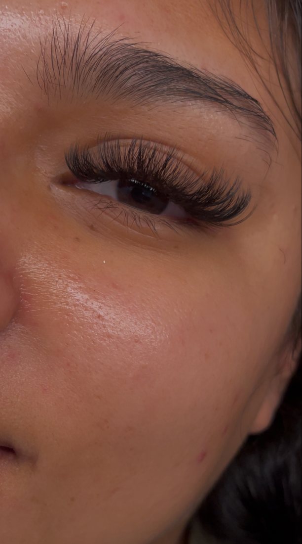 Client with soft, full lash extensions, close-up