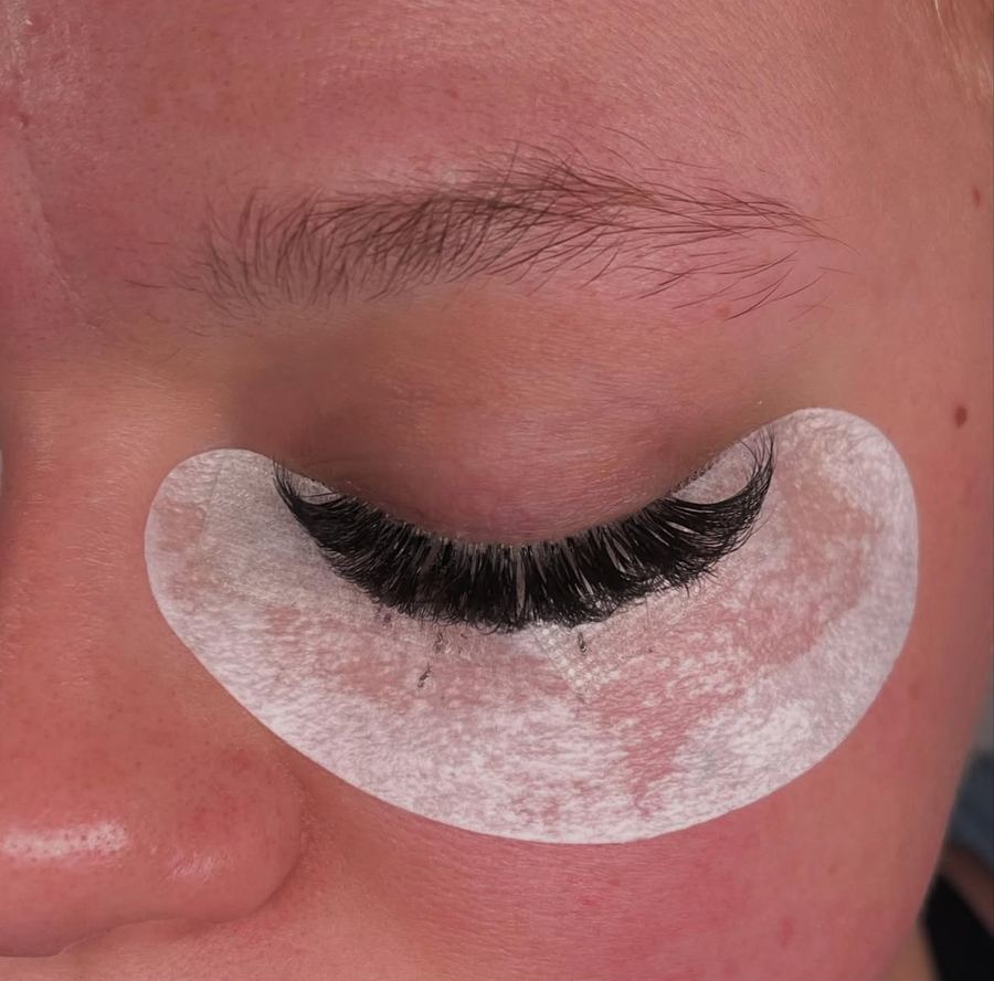Close-up of lash extensions with an under-eye gel pad